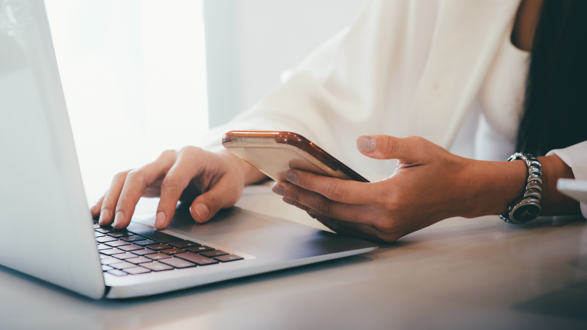 User checking mobile and laptop